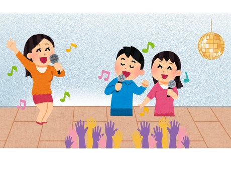 Image of a woman and two children singing with a disco ball in the background