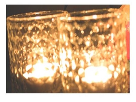 Two tealights lit in jars
