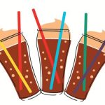 Three cups are filled with root beet and whip cream at the top with two different color of straws in each glass cup