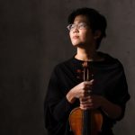 violinst Clara Kim holding violin