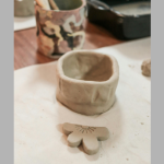 clay vase with tools in cylinder