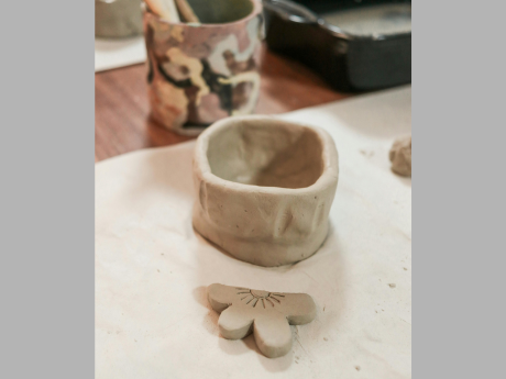 clay vase with tools in cylinder