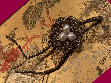 wire worked bird's nest with pearls on japanese pattern background