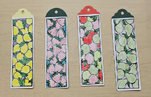 Four bookmarks with lemons, strawberries, apples, and pears colored with pencils