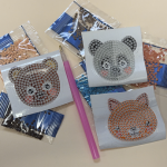 diamond painting stylus with three animal sticker bases and packets of plastic beads