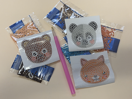 diamond painting stylus with three animal sticker bases and packets of plastic beads