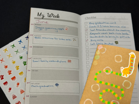 mini weekly planner with stickers and cover decorated with giraffe and dot stickers