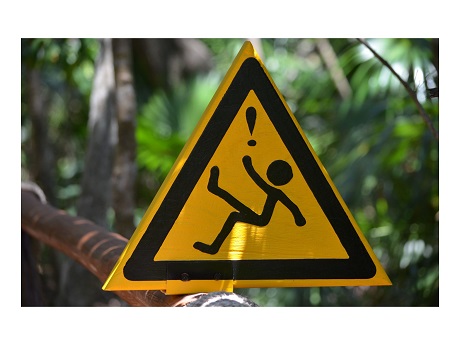yellow triangular sign with icon of person falling
