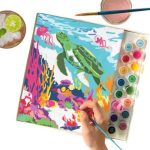 paint by numbers image, hand with paintbrush, paint, top view of a drink with ice and lime