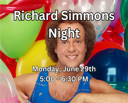 Richard Simmons sitting in a pile of brightly colored balloons.