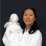woman holding a white puppet
