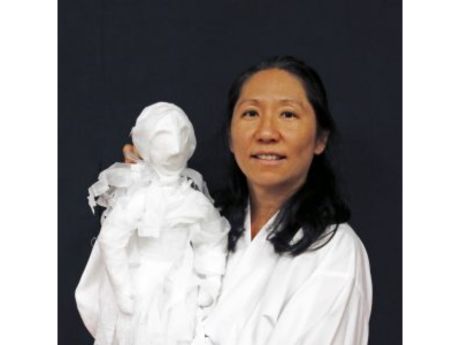 woman holding a white puppet