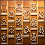 a variety of decorative knots on a wooden board