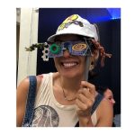 person holding up upcycled glasses in front of her face