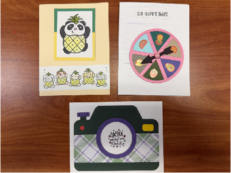 3 handmade cards: panda dressed as pineapple, wheel with fruit, and camera