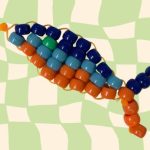 Pony bead fish keychain on checkered background