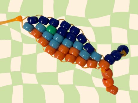 Pony bead fish keychain on checkered background