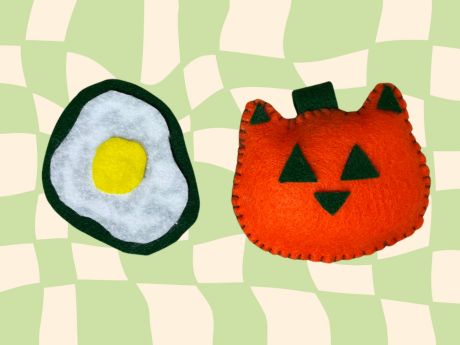 Felt patch shaped like a fried egg and an orange felt cat pumpkin plushie