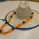 Orange Lei made out of LEGOS on straw hat