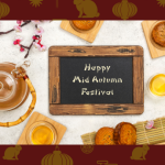 red and yellow background with picture in center of chalkboard, tea, and moon cakes on a table